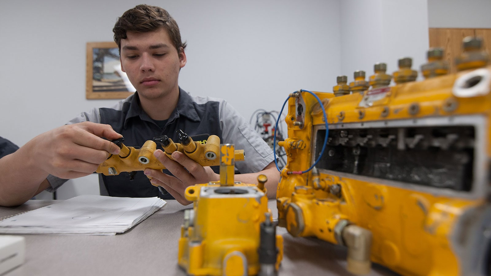 A CF TECH student gets hands-on experience with a component.