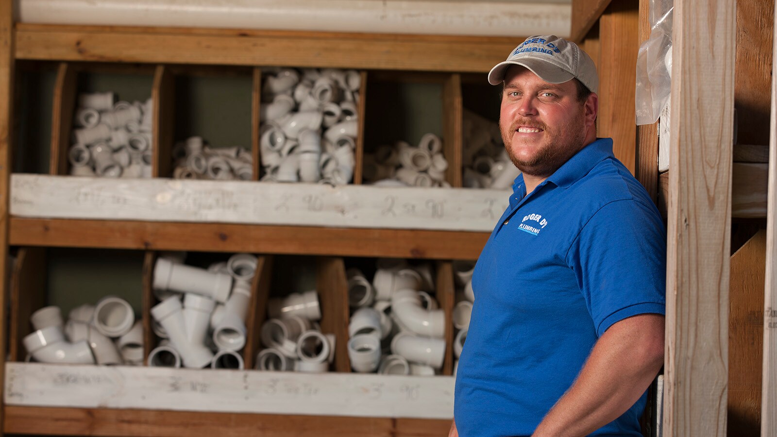 Roger Haislep stands in front of his PVC plumbing parts bins.
