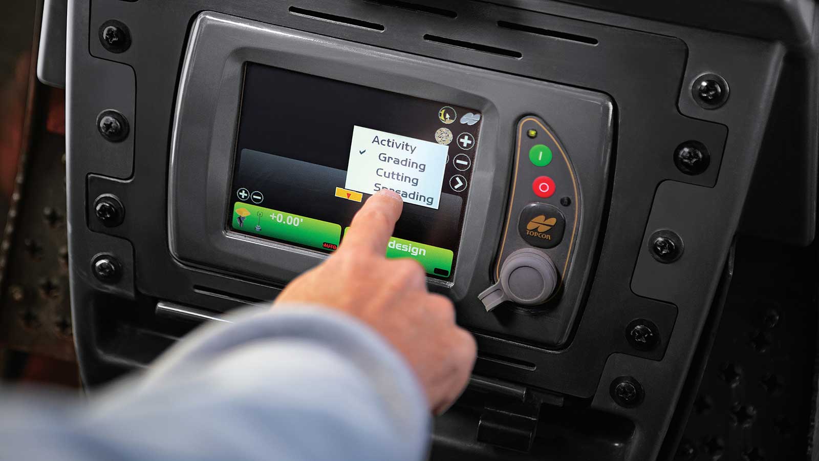Operator turning on SmartGrade on an in-cab monitor