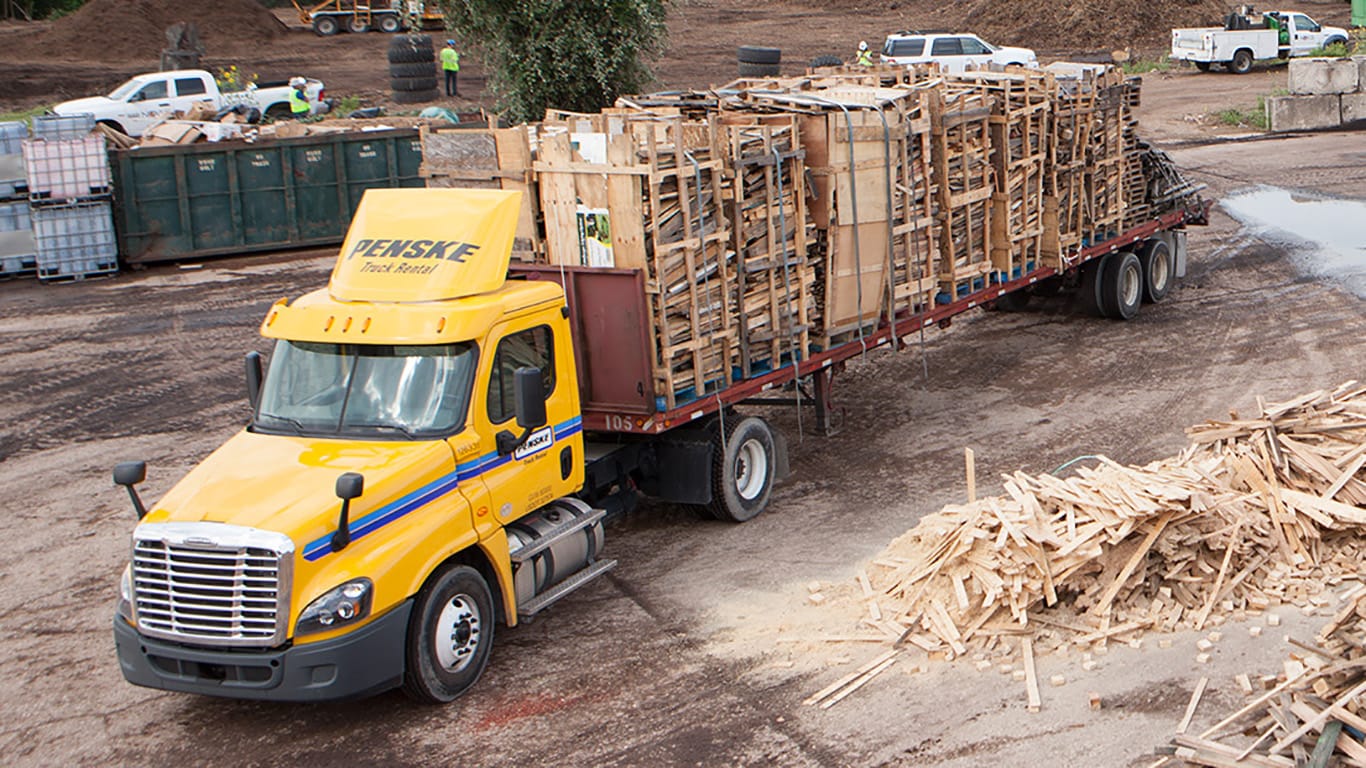 A truck is loaded with wood scraps