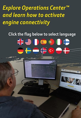 Person at a desk using two computer screens with text about exploring Operations Center and selecting a language.