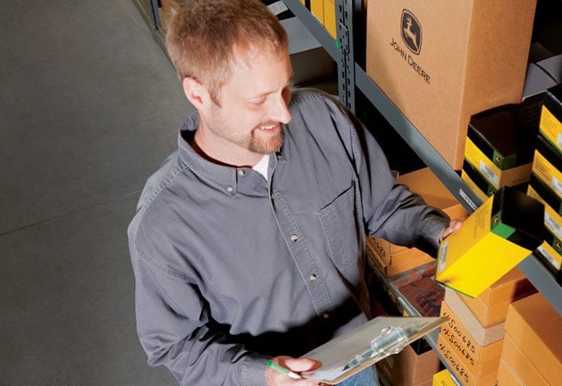 John Deere employee picking out a part for a customer