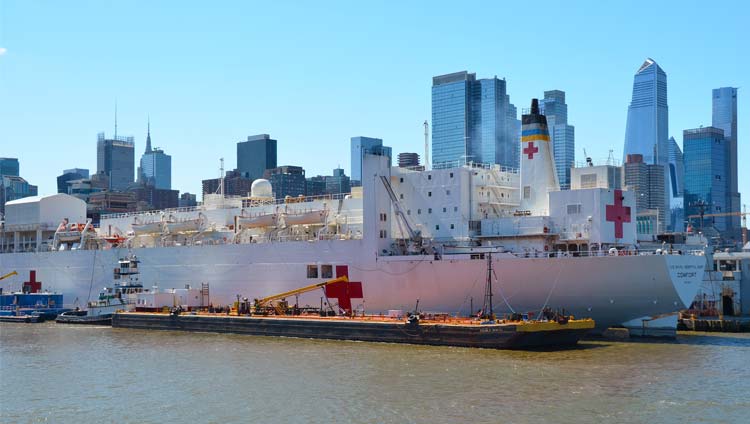 Vane Brothers tugboat performing the bunkering operation on USNS Comfort hospital ship in New York Harbor