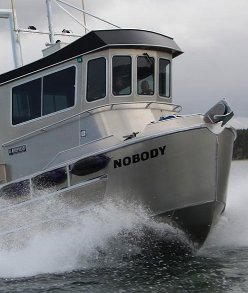North River's new Bristol Bay sport fishing boat powered by a John Deere Marine engine cruising the water