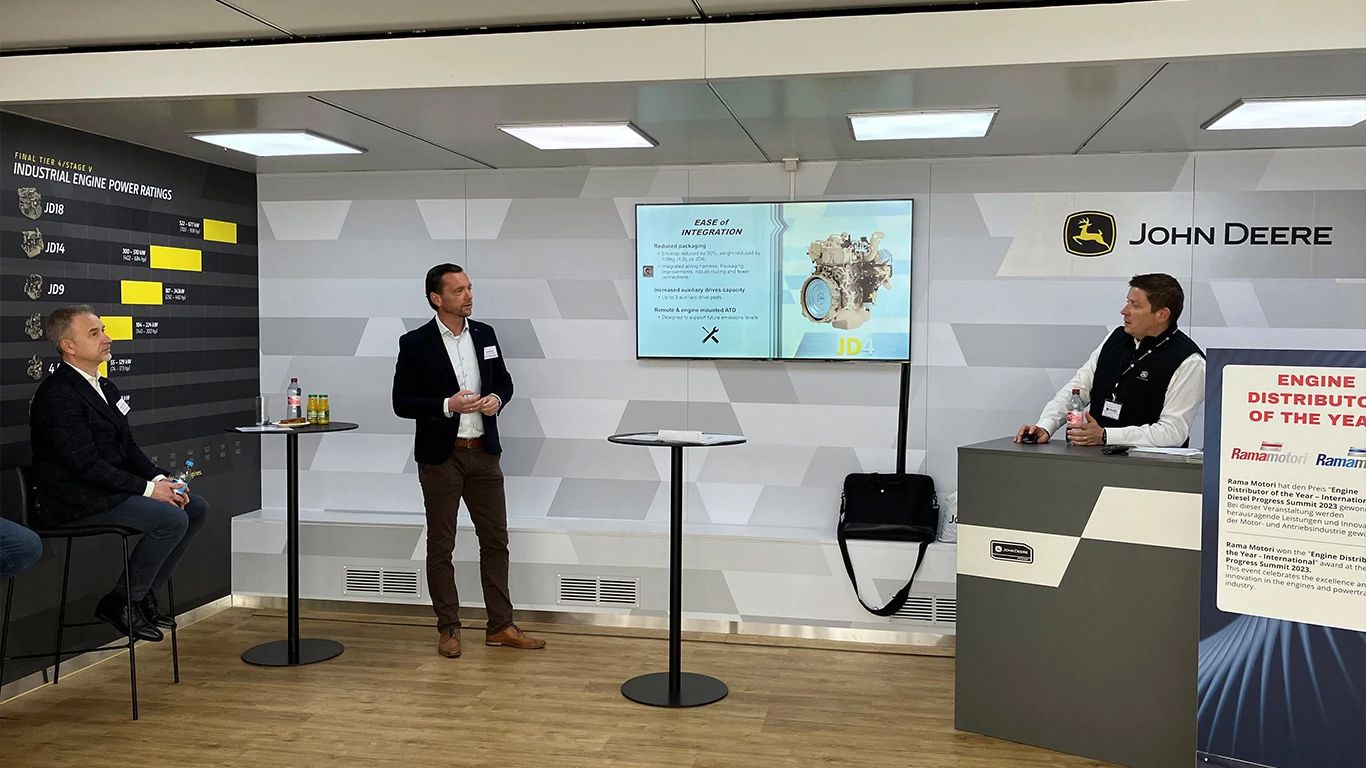 John Deere experts presenting on the JD4 industrial engine in the Road Show truck.