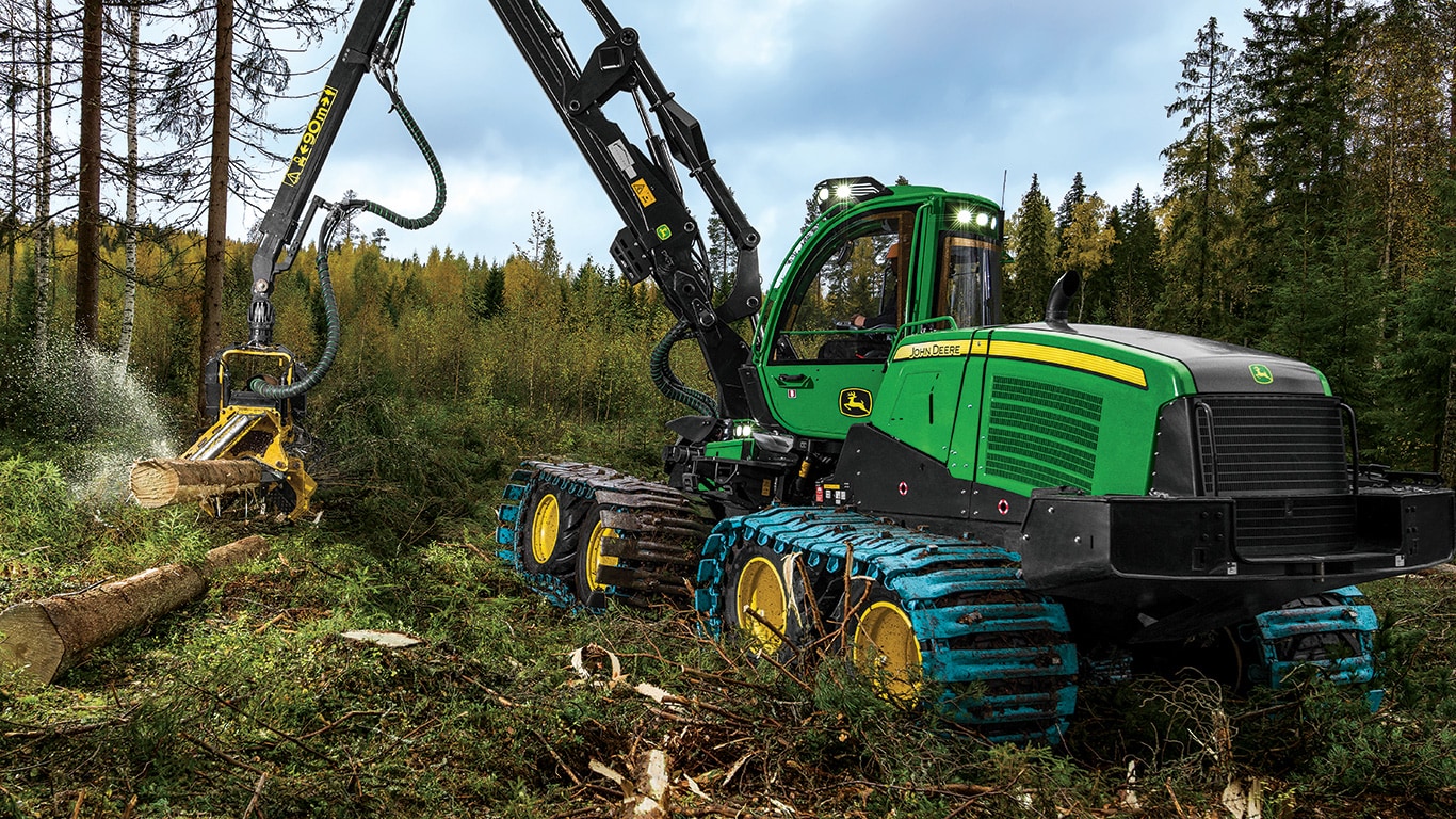A John Deere 1170G Wheeled Harvester with H414 harvesting head is processing felled logs.