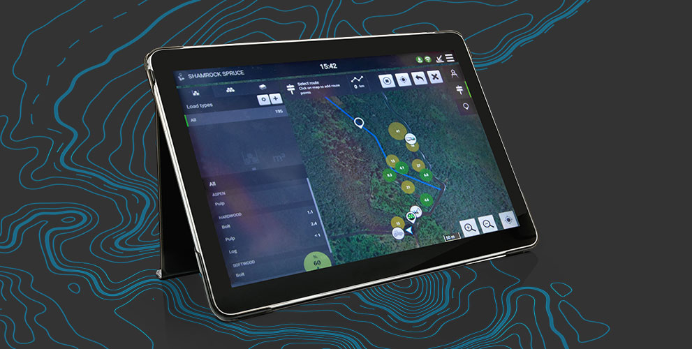 Tablet showing a Timber Matic map on the screen with a topographic map behind it