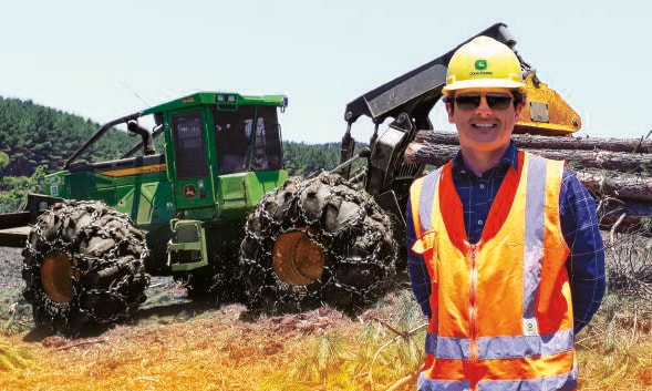 Crystian Fracasso stands in front of a skidder