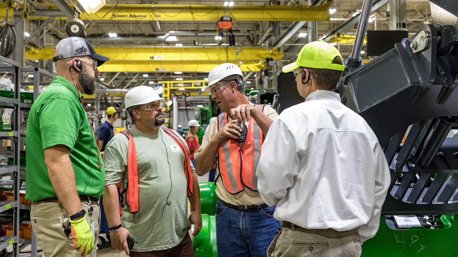 Roger Ferguson talks with Deere employees during his Gold Key factory tour