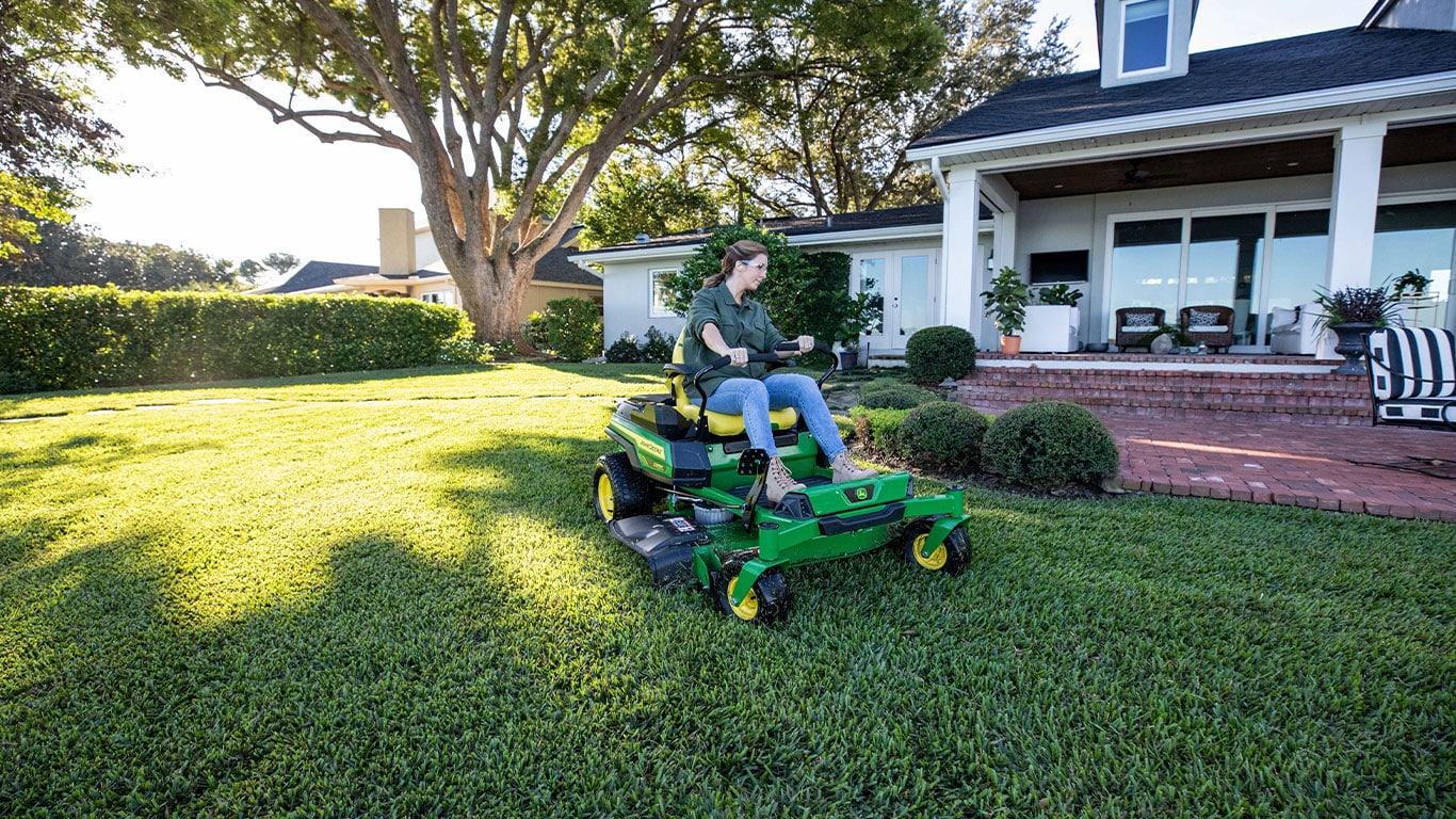 Wide-frame photo of Z370R Electric ZTrak Mower cutting the backyard