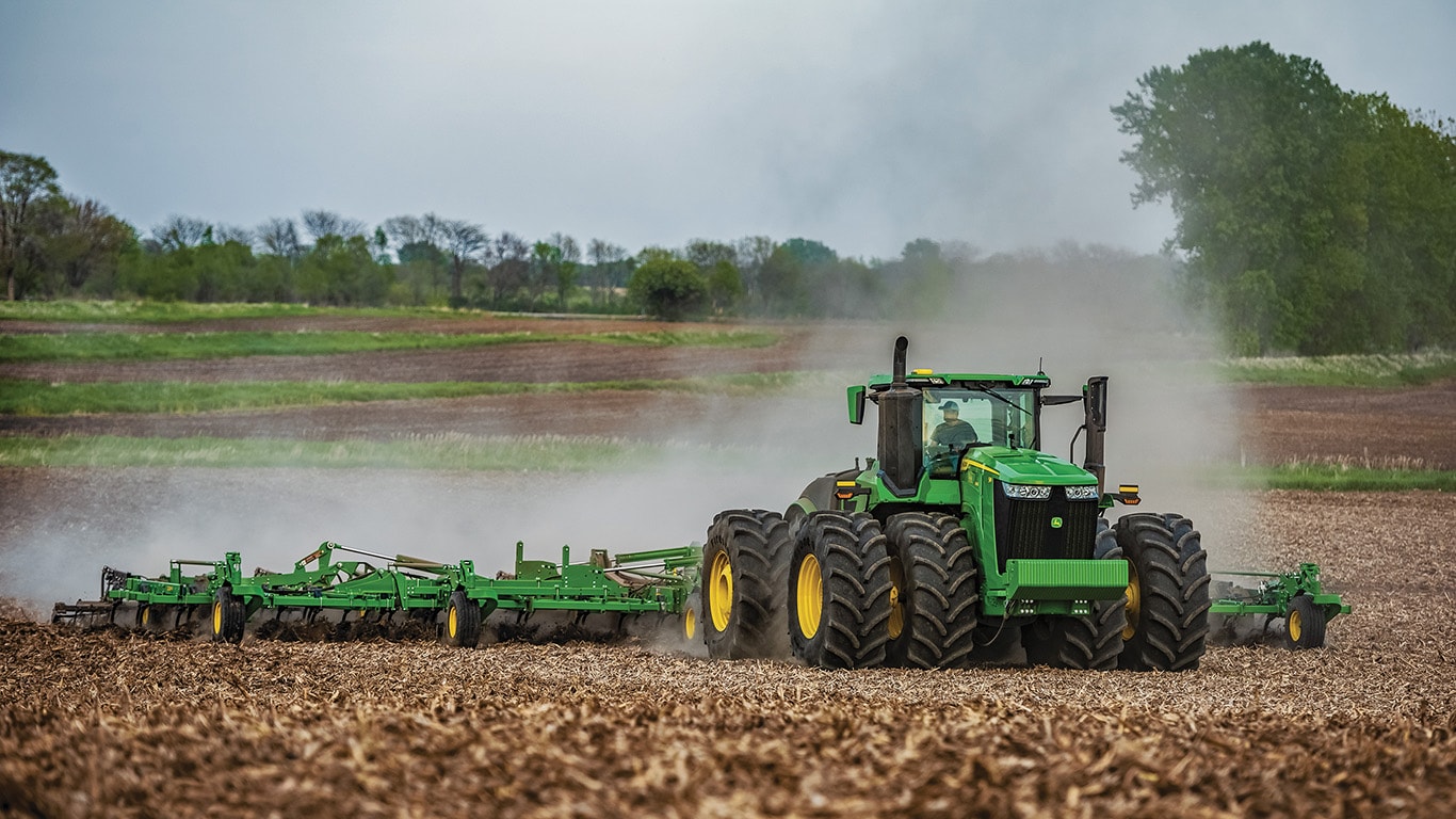 9 Series Tractor pulling an implement through a field