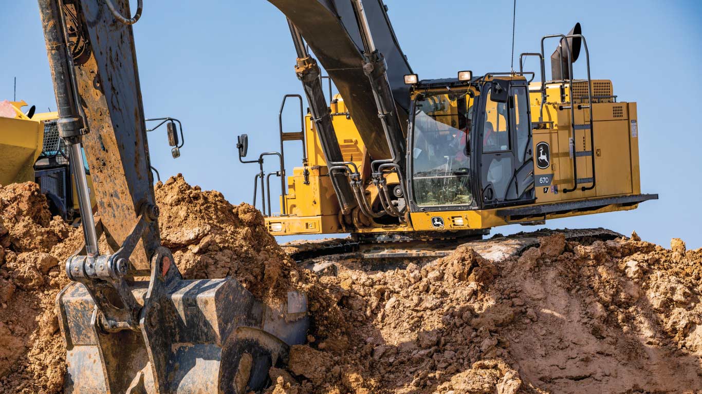 670 P-Tier excavator scooping dirt into a bucket