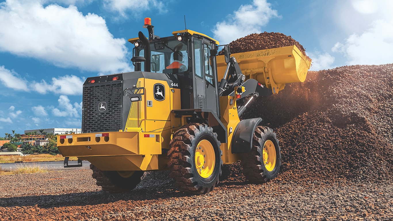 444 G-Tier Wheel Loader scooping rocks into bucket