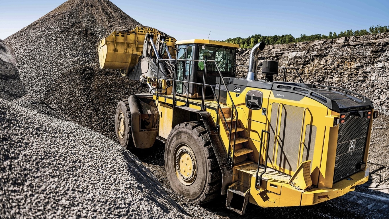 944 X-Tier wheel loader scooping rocks into the bucket