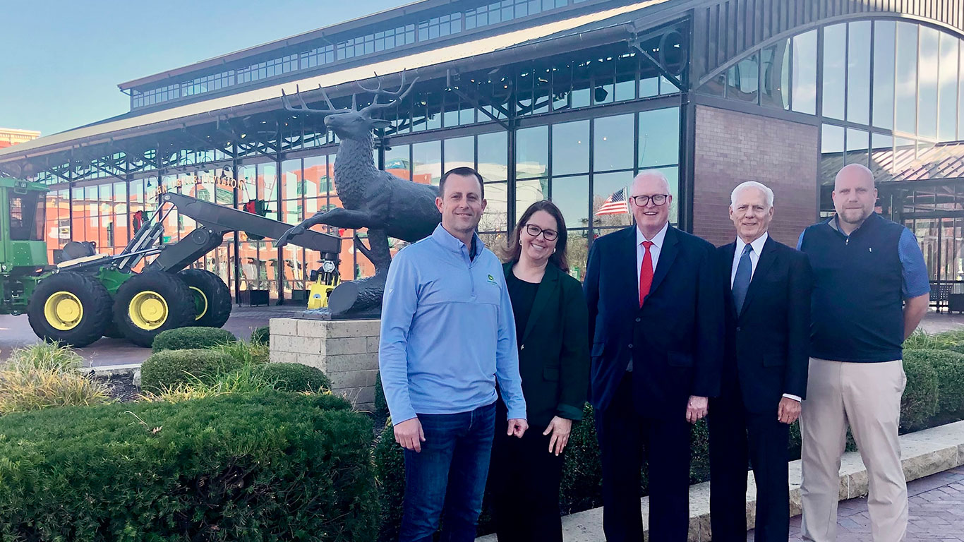 ohn&nbsp;Deere and AED Foundation Executives standing outside the John&nbsp;Deere Commons building