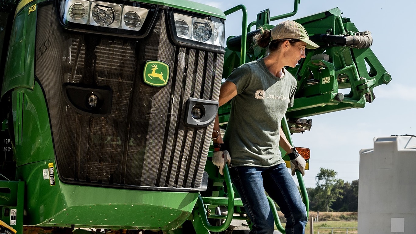 A female farmer works comfortably in her Dovetail Workwear jeans and tshirt