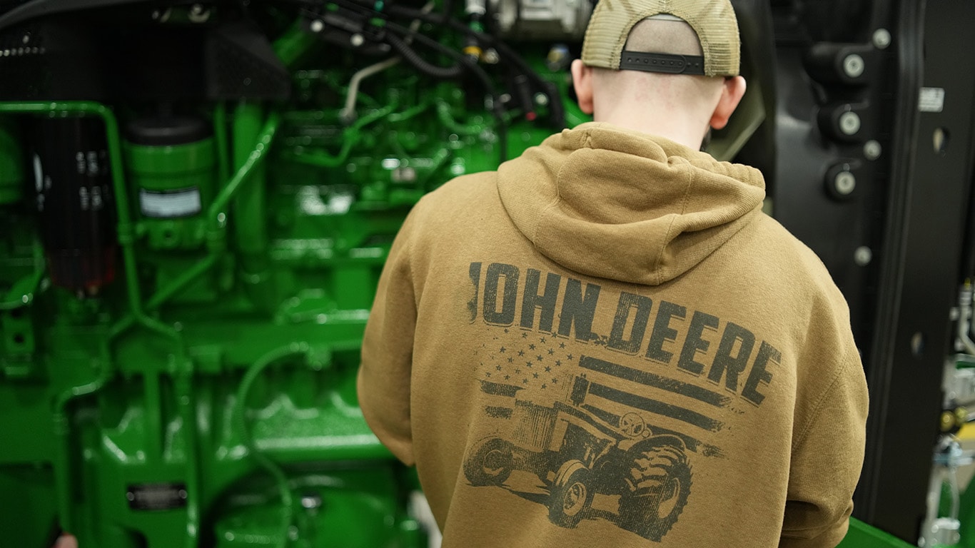 a Waterloo, Iowa factory production factory shows off his Deere pride with a branded sweatshirt