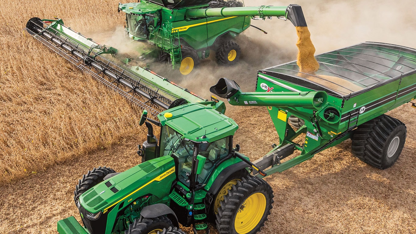 X9 Series Combine harvesting wheat along side of 8R Series Tractor, running on B30 Biodiesel fuel