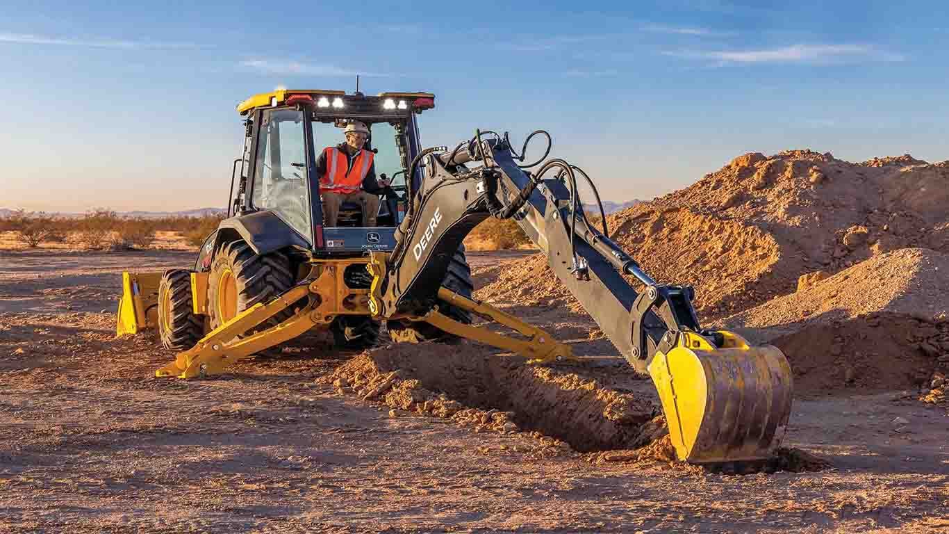 the upgraded 320 P-Tier Backhoe digging dirt