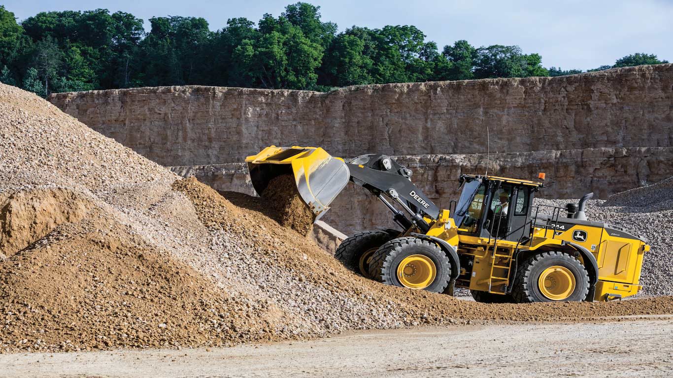 The 744 X-Tier Wheel Loader with full suite of SmartDetect™ solutions and E-Drive system dumping dirt  