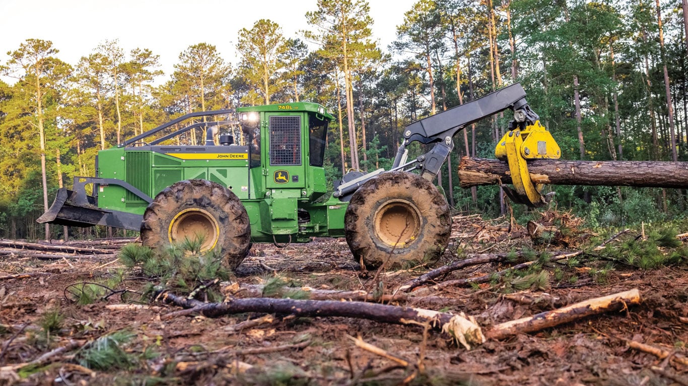 Action shot of the 748 L-III Skidder in the woods