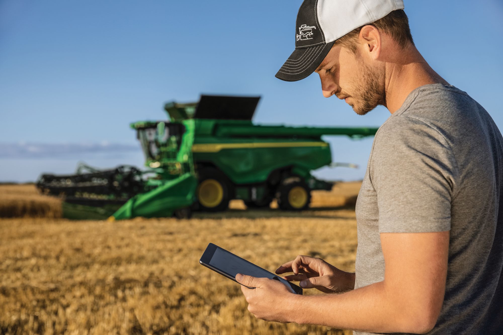 John Deere customer with combine in field