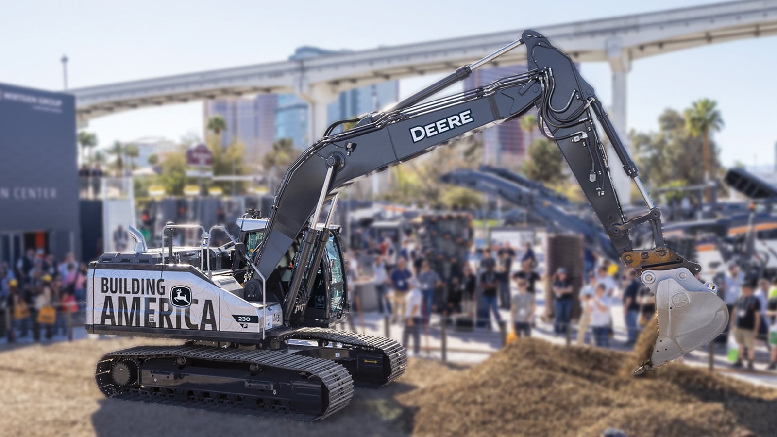 excavator moves earth with spectators surrounding it to watch