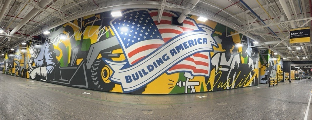 mural says "Building America" on a factory wall