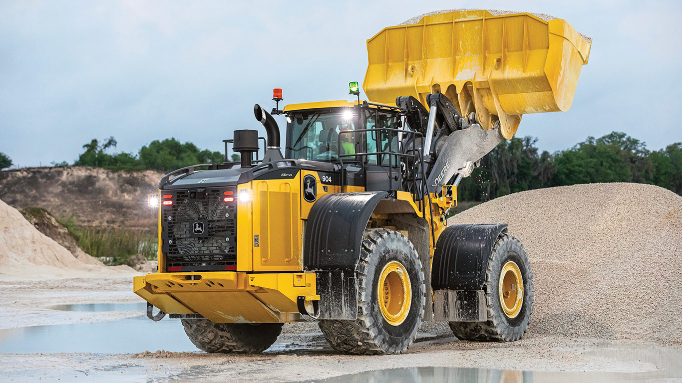 904 X-Tier Wheel Loader scooping gravel in the bucket lifted above the pile
