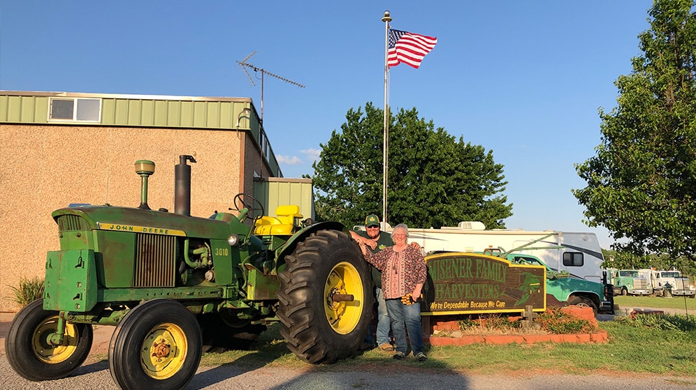 two people pose with 1963 John Deere 3010 LP Standard