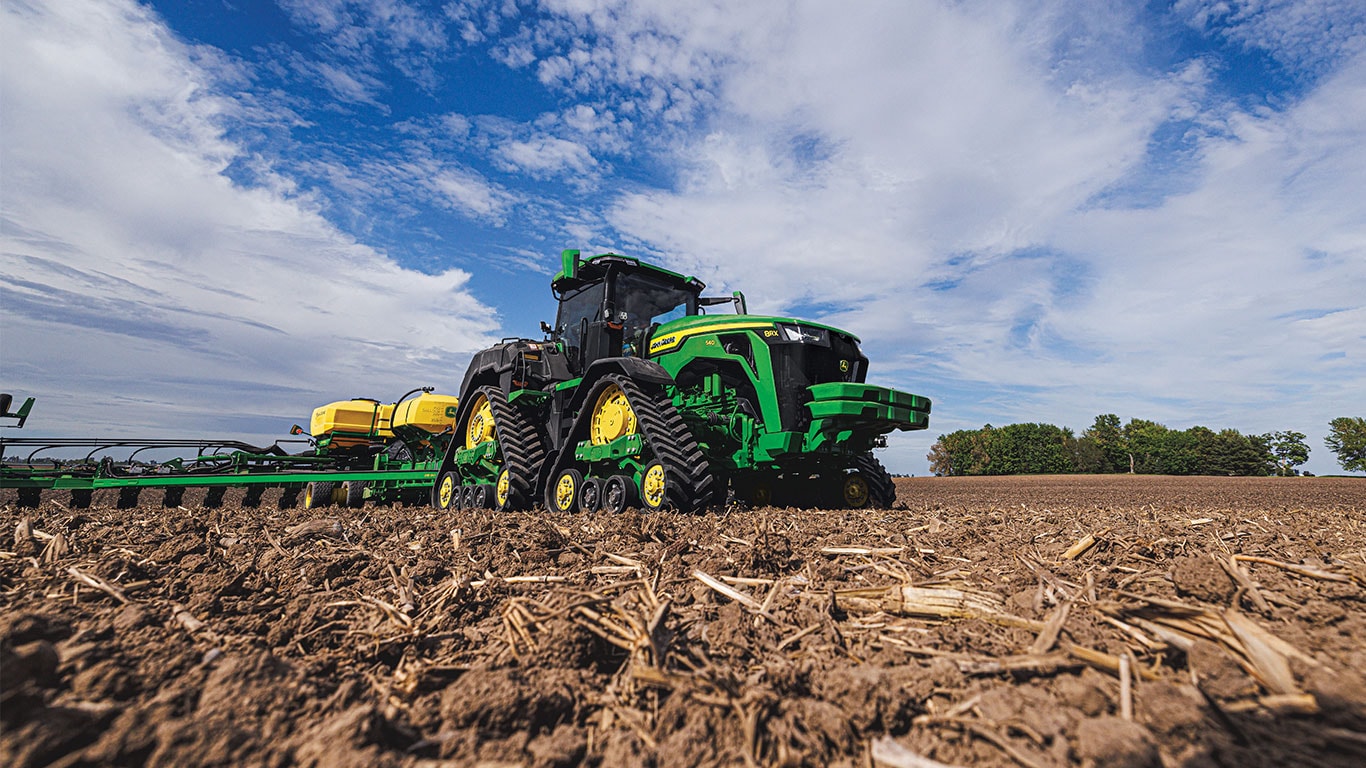 8RX 540 pulling a planter through the field