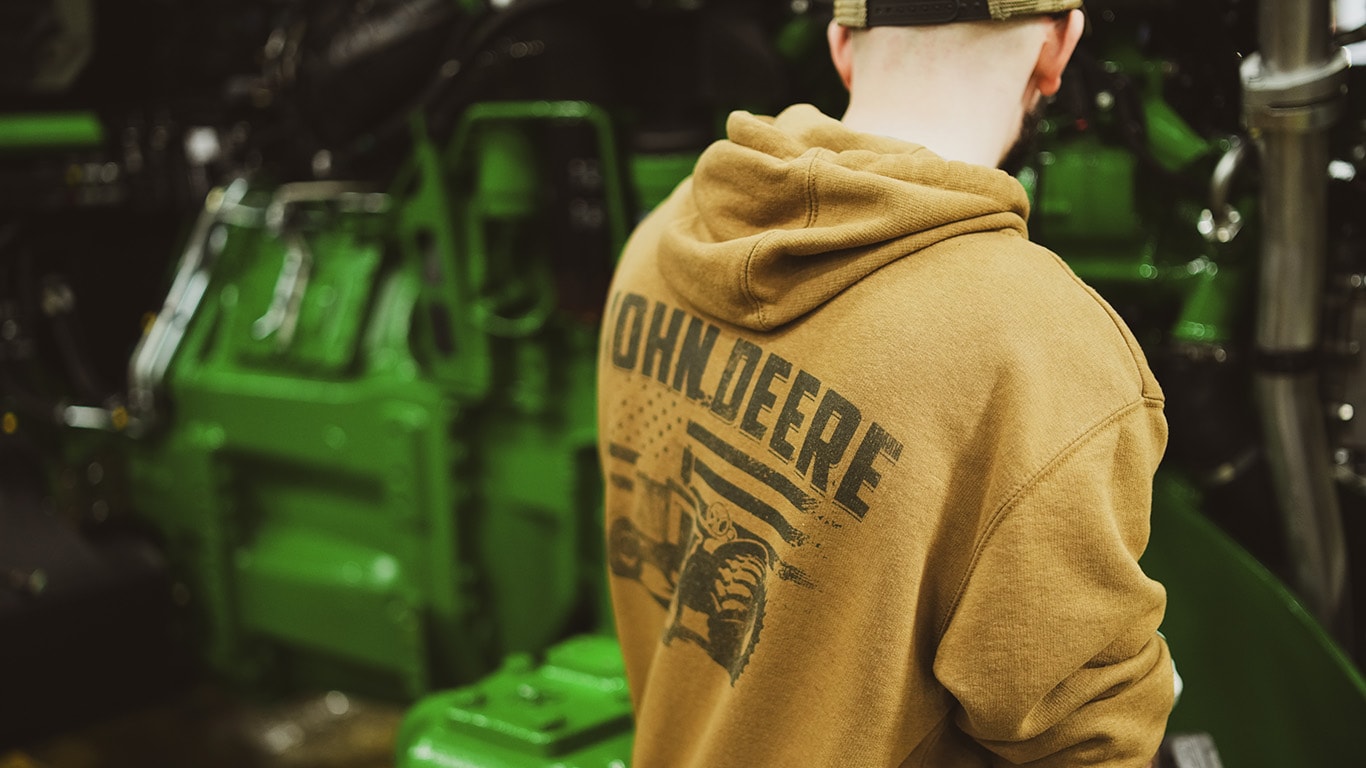factory employee working on tractor assembly line