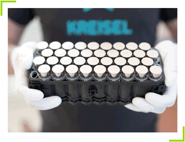 A gloved person holding a Kreisel electric battery