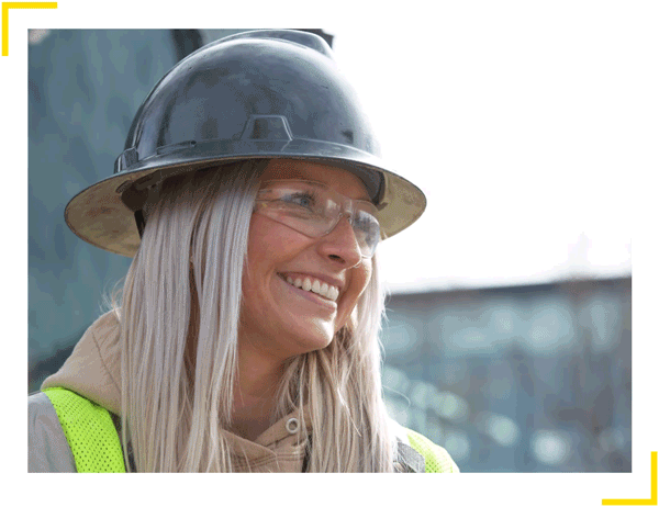 A female construction worker smiling for the camera