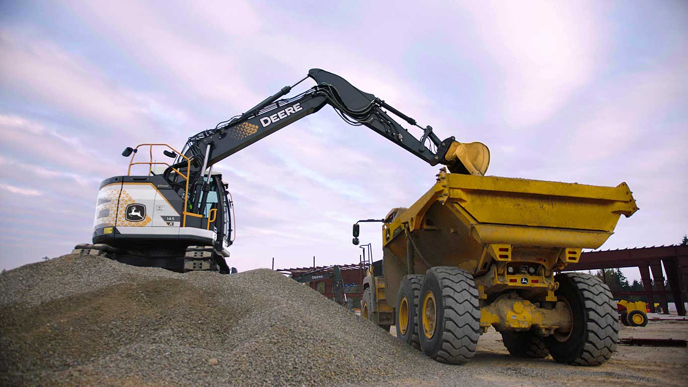 John Deere 145 X-Tier Excavator loads a 260E Dump Truck