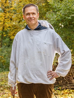 Photograph of Gilles Dryancour in front of trees