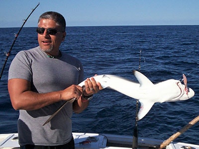 Man holding a shark