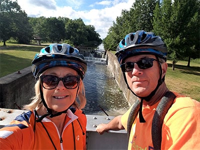Couple biking near canal