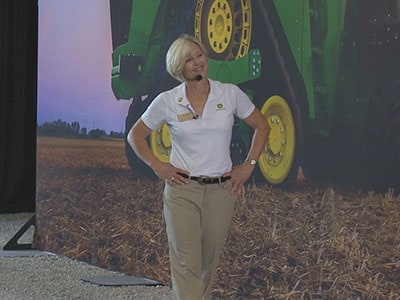Woman speaking at John Deere Farm Progress Show