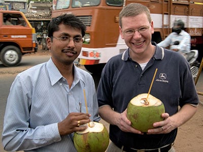 Two men holding fruit