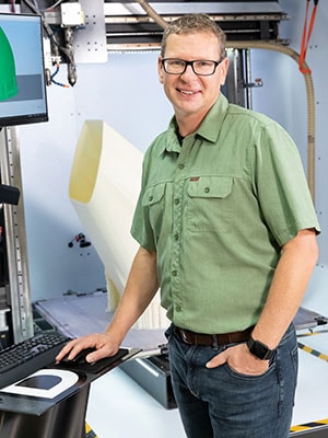 Man standing at a computer
