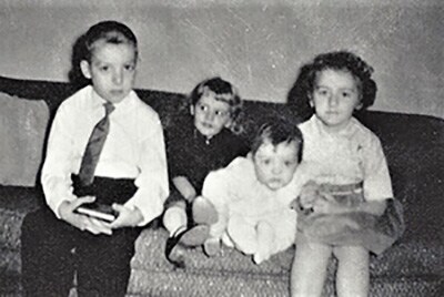 On the sofa, from left, are the Mack children Tom, Carol, Lori, and Connie.