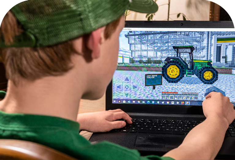A student works on a John Deere tractor creation in the Minecraft game