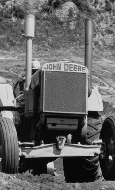 Model "DI" tractor emerging from gravel pit, 1935