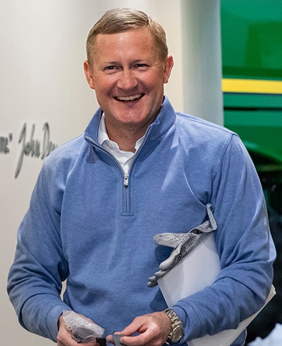 John May walking down a hall at the Harvester Works factory in East Moline, Illinois, United States