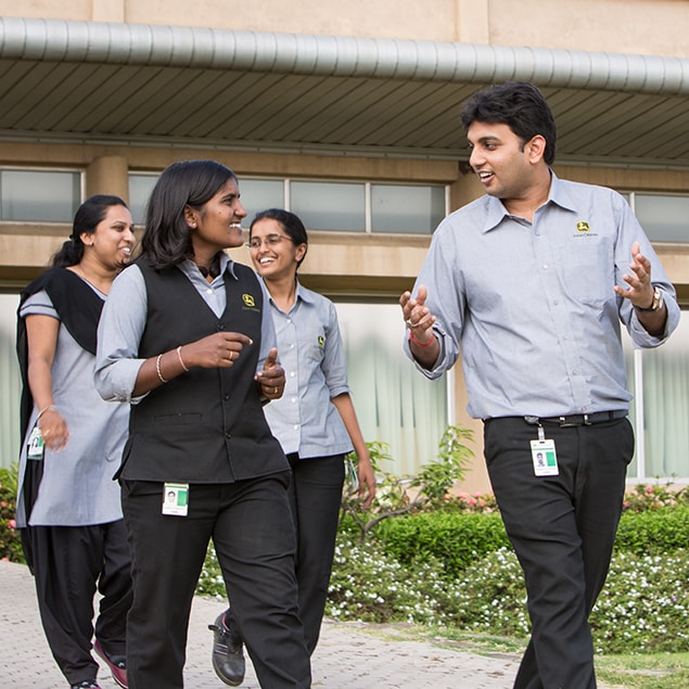 John Deere employees walking away from the exterior of the Pune Works building located in Pune, Maharashtra, India