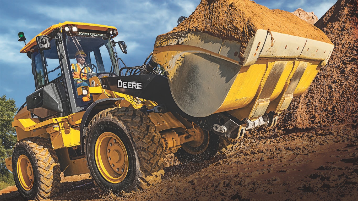 A 444L Wheel Loader moving dirt on a jobsite.