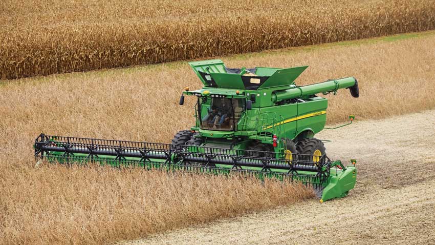 A john Deere combine working through a field