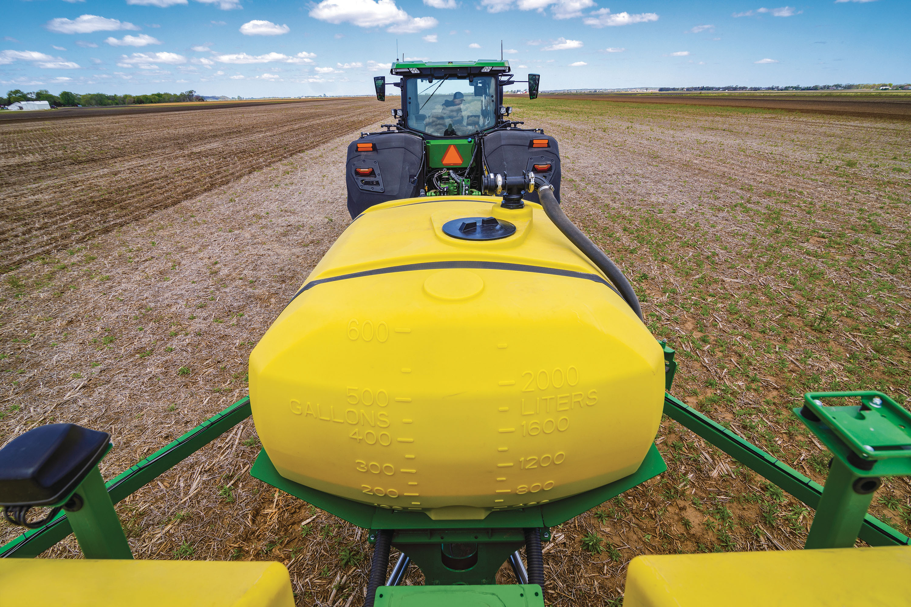 Rear view of CCS tank behind tractor in a field.