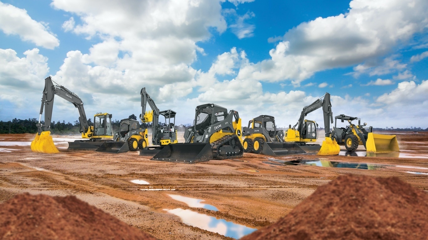 John Deere construction equipment lined up on the jobsite